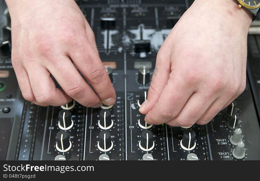 Hands near the disc jockey music equipment. Hands near the disc jockey music equipment