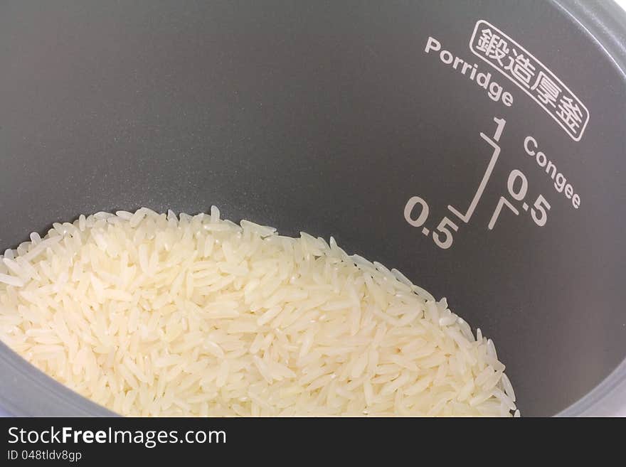 Raw white Jasmine rice in a rice pot