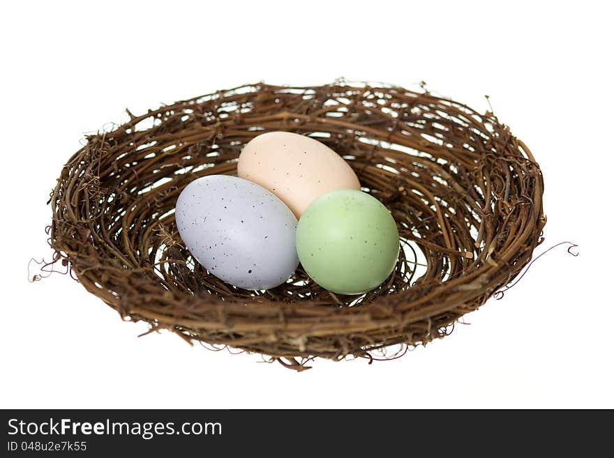 Colorful speckled animal eggs in a nest, isolated on white. Colorful speckled animal eggs in a nest, isolated on white.