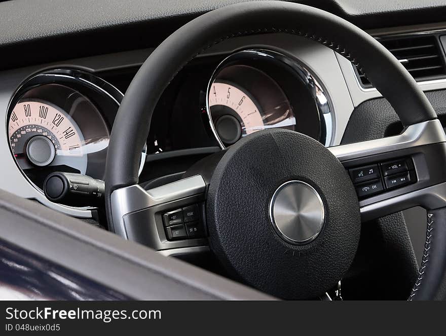 Dark colored dashboard of modern car made in retro style