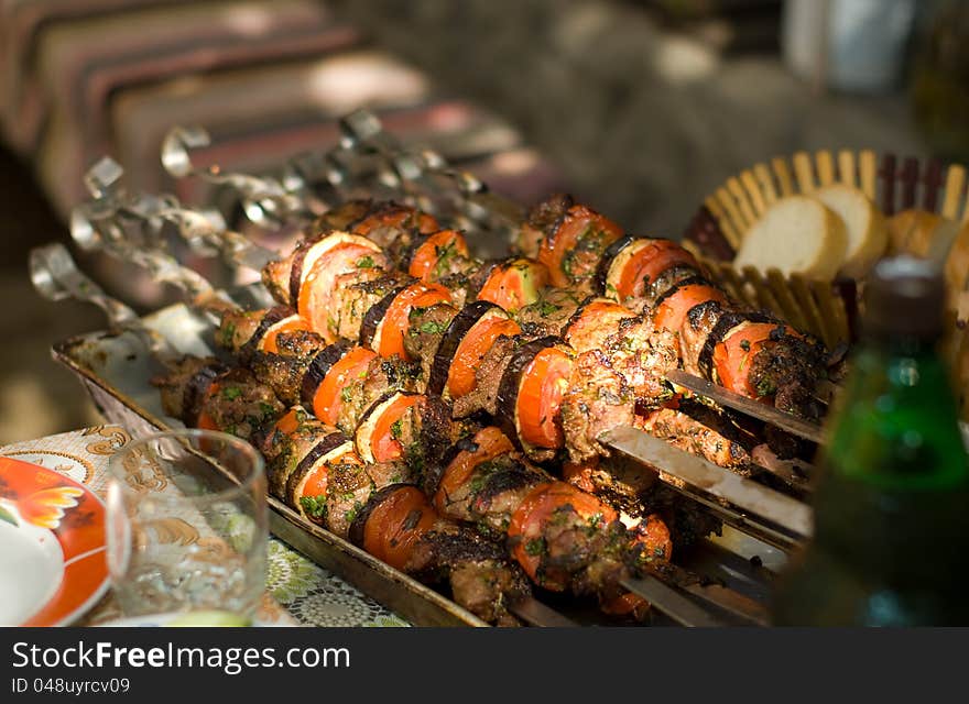 Kebab skewers with vegetables on a table close-up