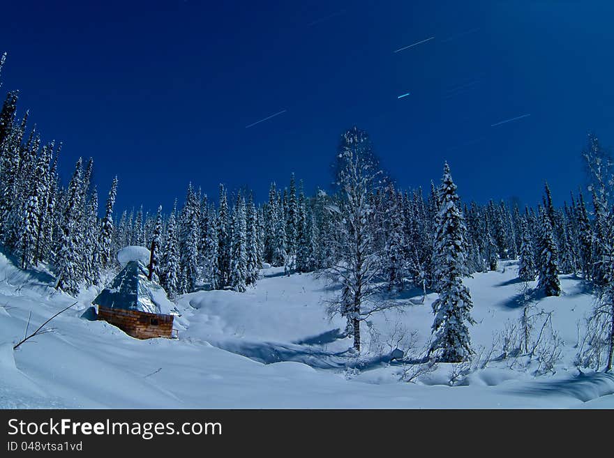 Small house in winter forest