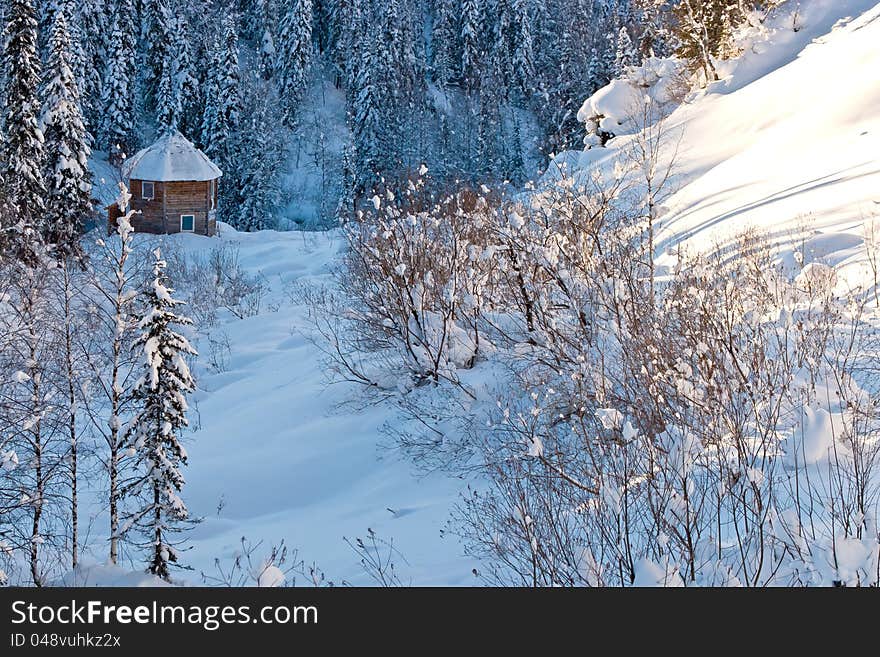 Small house in winter forest in Siberia