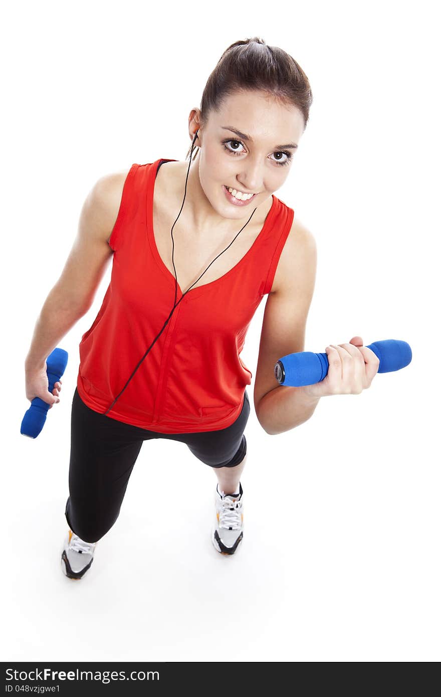 Young pretty fit woman exercising with weights while listening music. Studio Isolated on white. High key. Young pretty fit woman exercising with weights while listening music. Studio Isolated on white. High key