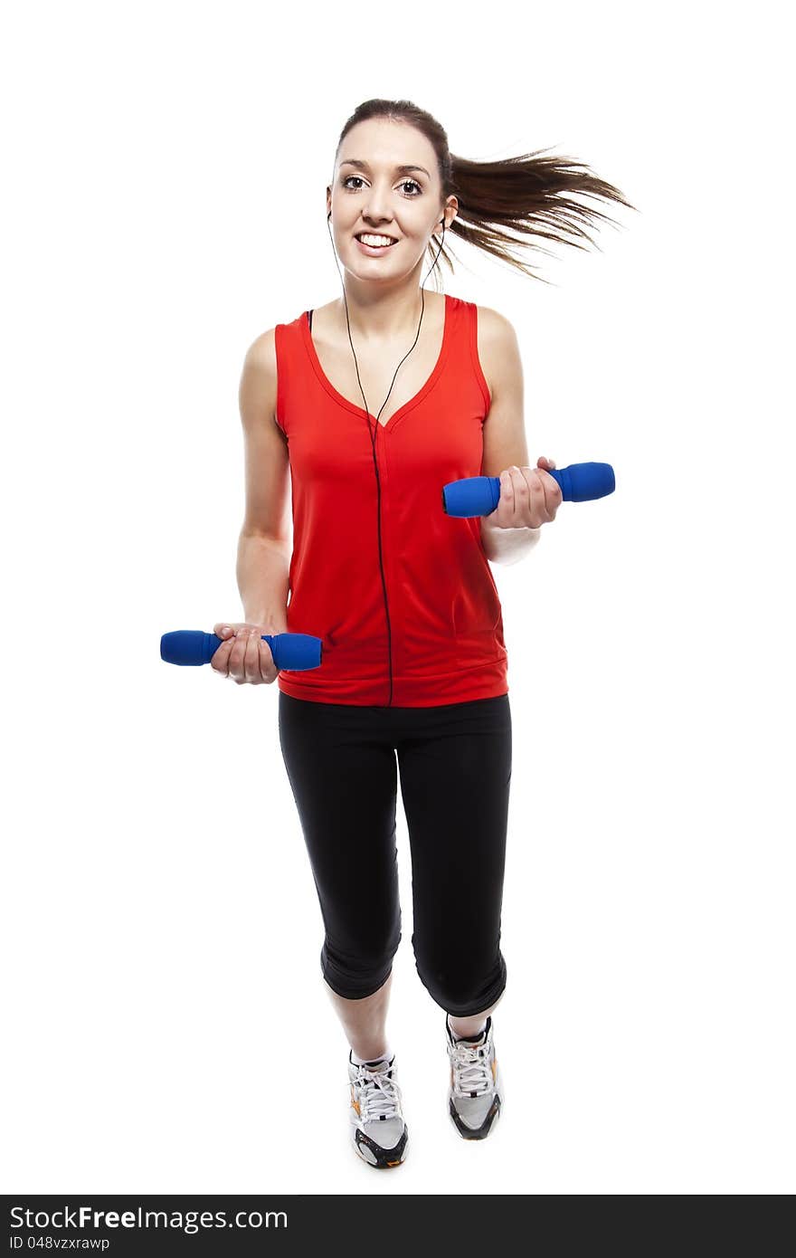 Young pretty fit woman exercising with weights while listening music. Studio Isolated on white. High key. Young pretty fit woman exercising with weights while listening music. Studio Isolated on white. High key