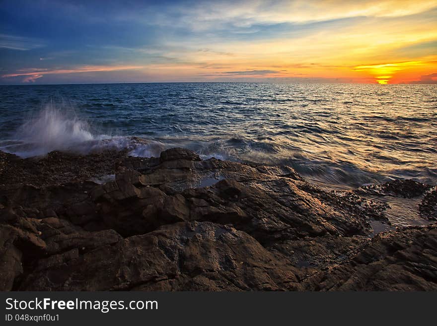 Sea beach and rock on sunset time as background