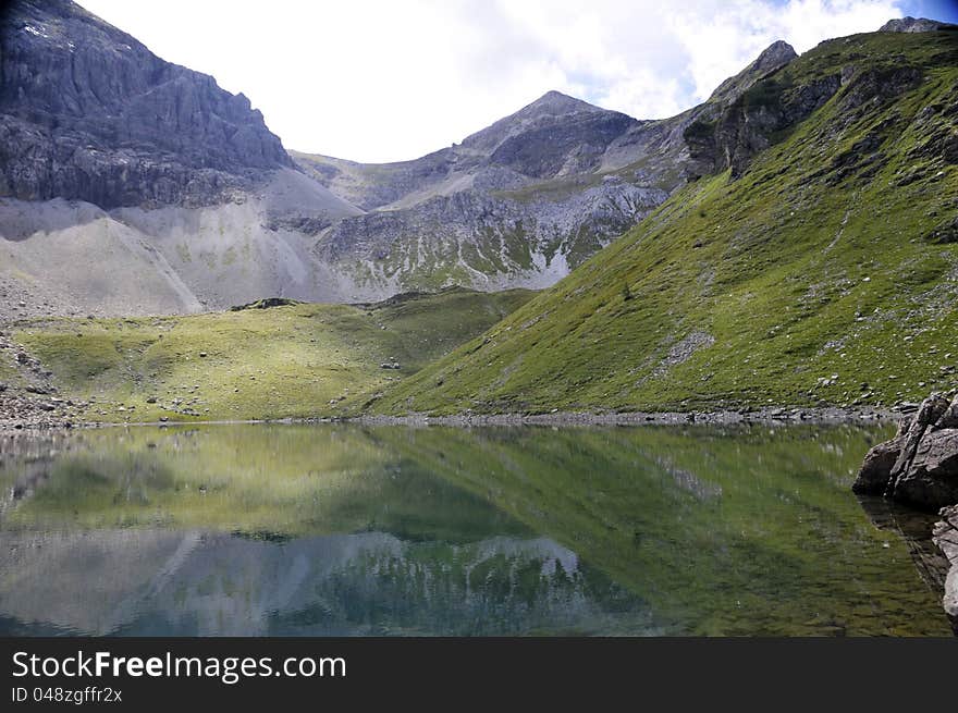 Alpine lake surrounded by mountains in Obertauern area, Austrian Alps, Europe