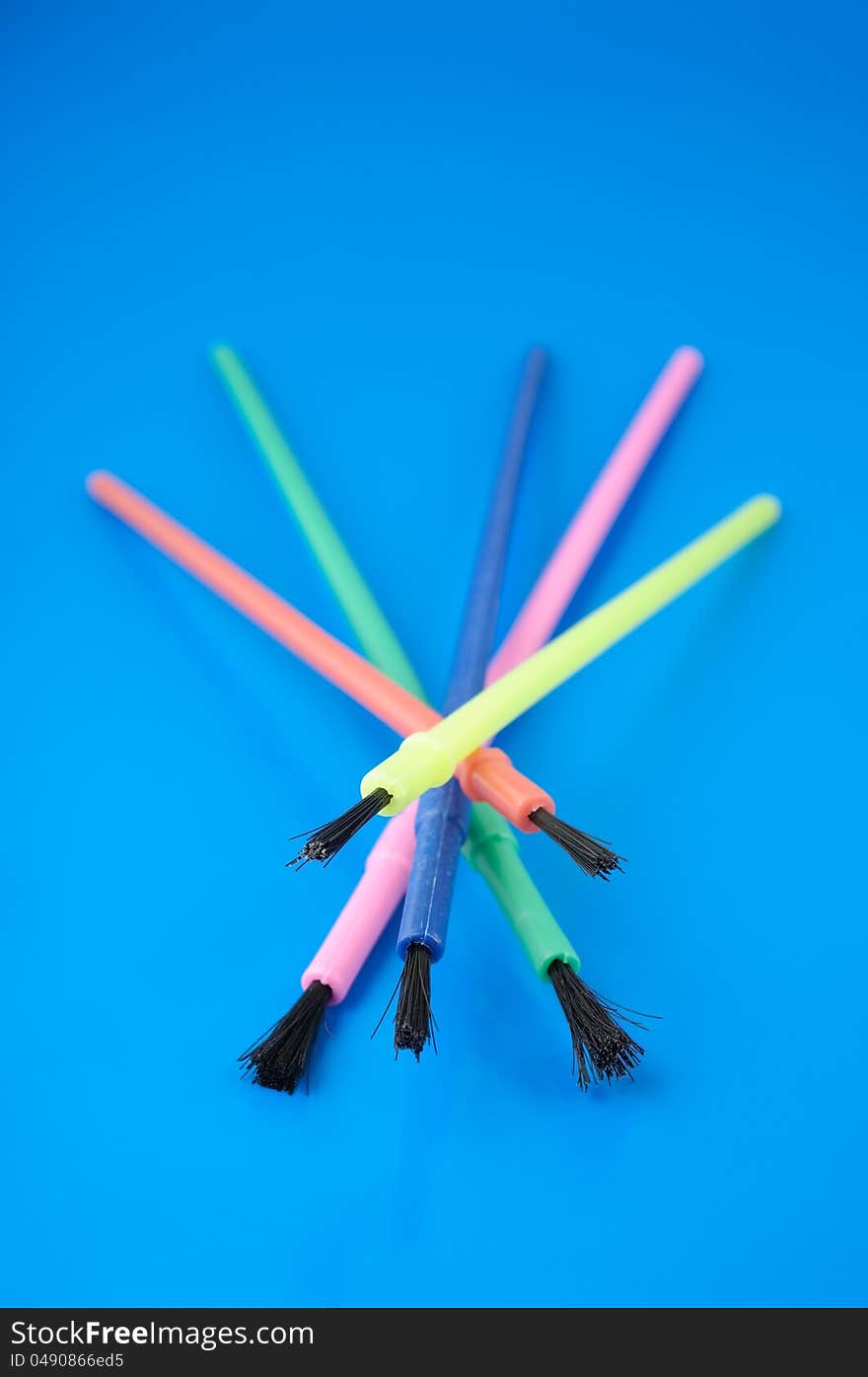 Colorful Plastic Paint Brushes on Blue Background. Colorful Plastic Paint Brushes on Blue Background