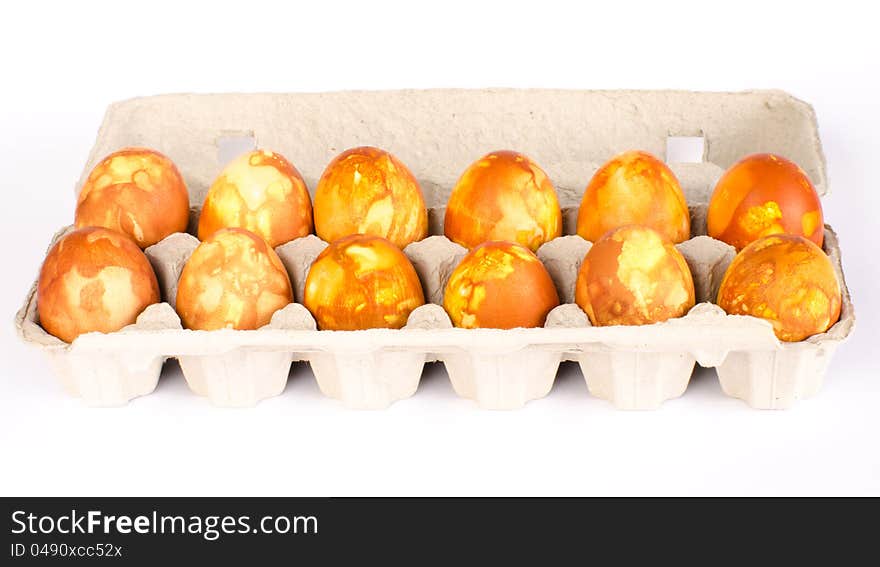 A carton of a 12 naturally dyed golden marbled Easter eggs. A carton of a 12 naturally dyed golden marbled Easter eggs