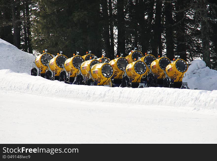 Snow cannons standing in a row