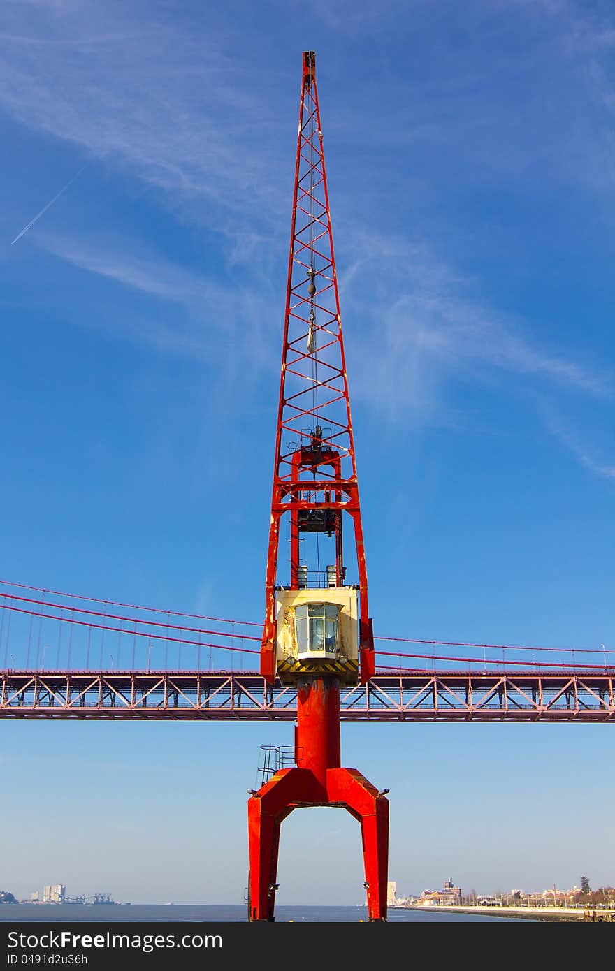 Red crane and red metallic bridge in port. Red crane and red metallic bridge in port