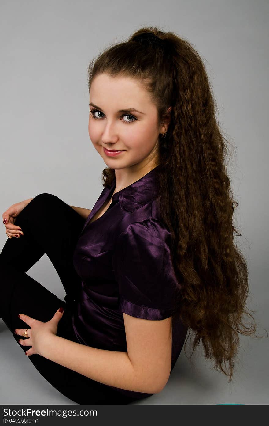 Portrait of sitting beautiful  brunette woman with long hair