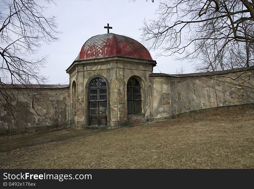 Chapel with glass windows, old chapel at the stone wall, chapel with a cross on the roof, chapel with red roof, chapel in the park in rychnov, chapel of the old facade