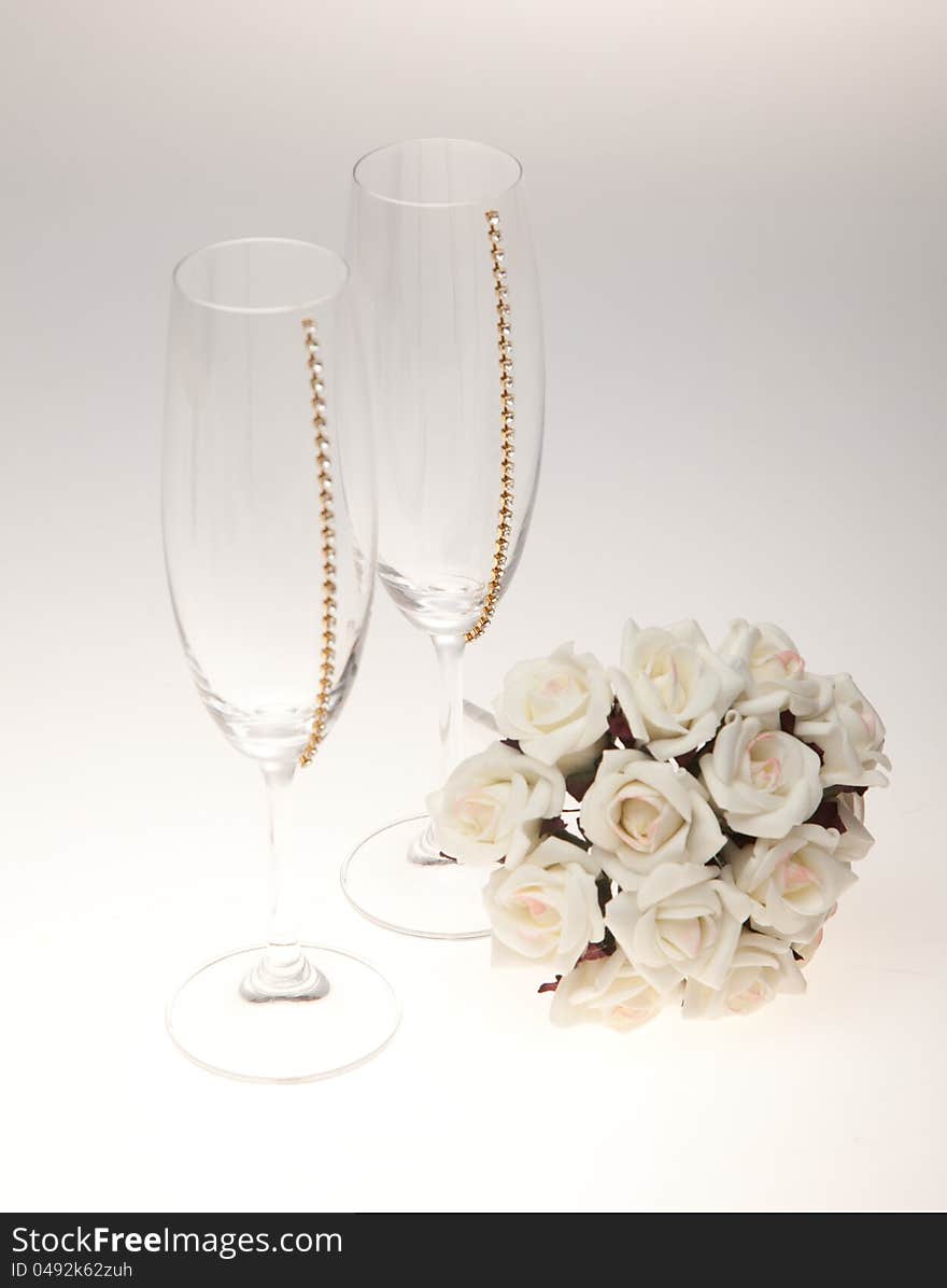 Bouquets and glasses on a white background. A bouquet of white flowers.