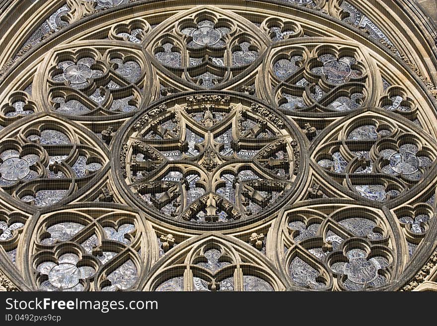 Detail the front of the cathedral of St. Vitus Cathedral, part of the cathedral in Prague, Prague monument, religious building in Prague one, with ornaments of architecture at Prague Castle. Detail the front of the cathedral of St. Vitus Cathedral, part of the cathedral in Prague, Prague monument, religious building in Prague one, with ornaments of architecture at Prague Castle