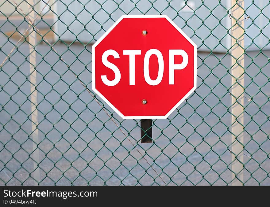 Stop sign on fence highlighting security