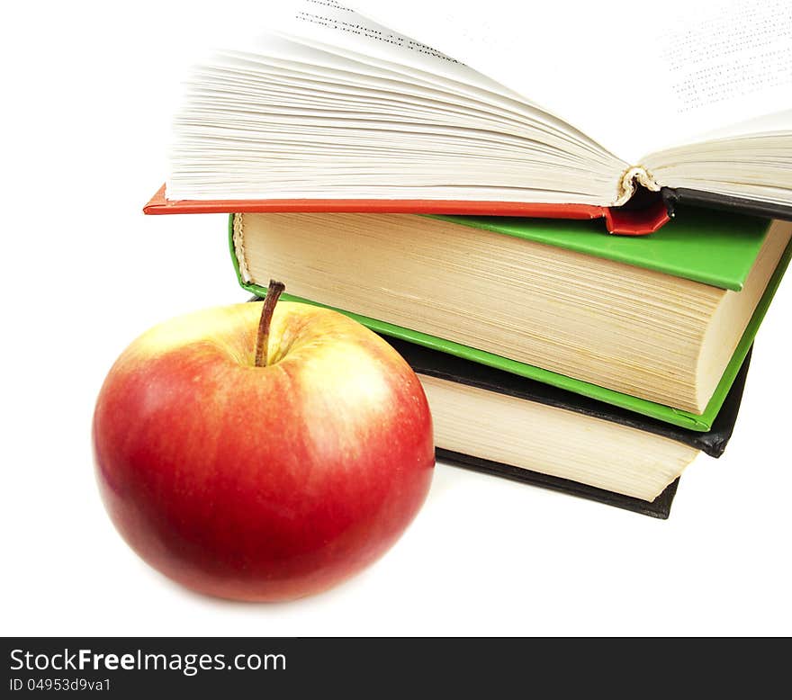 Book stack and apple on a white background. Book stack and apple on a white background