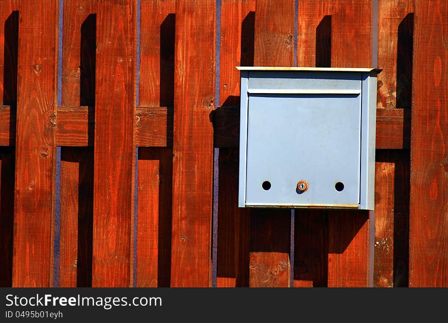 Mail box fixed on a wooden background