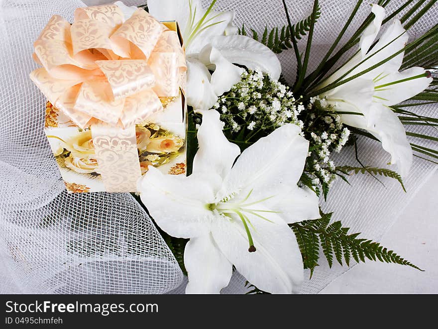 Bouquet of lilies with a gift