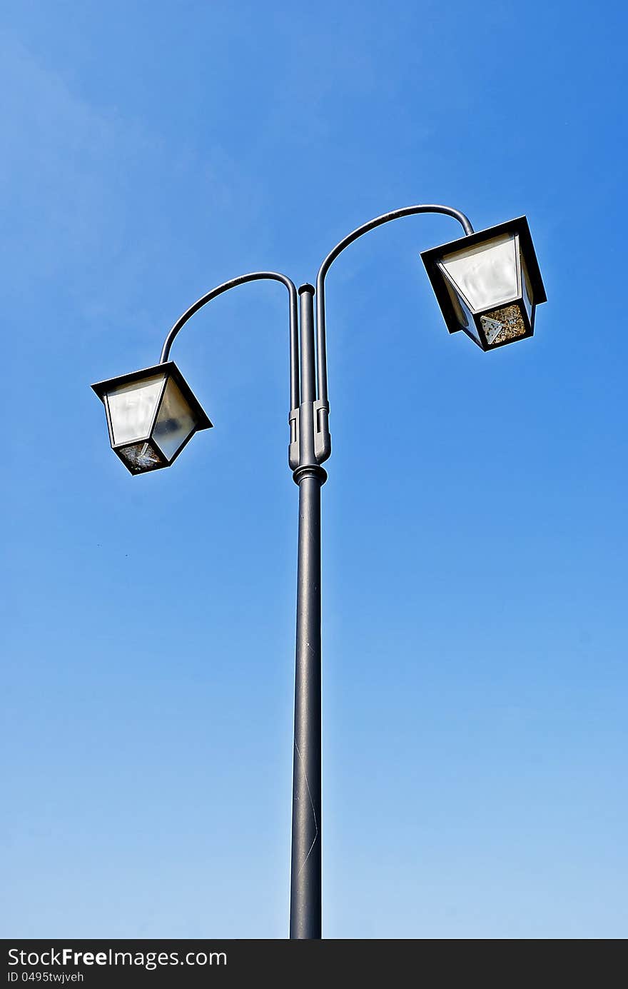 vertical shot of an old-fashioned street lamp in the sunlight. vertical shot of an old-fashioned street lamp in the sunlight.