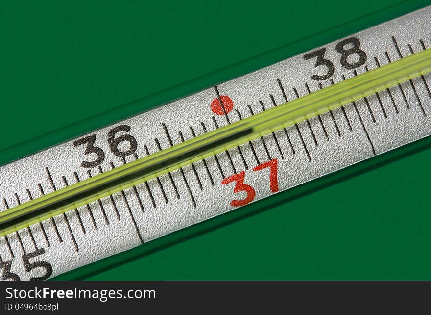 Medicine thermometer  on green background