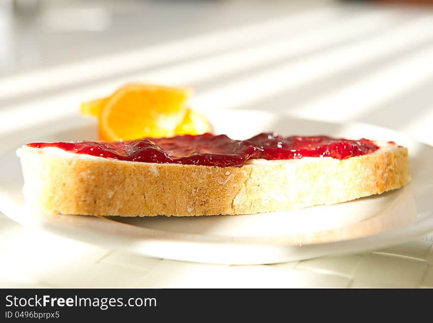 A pice of bread with jam in the morning