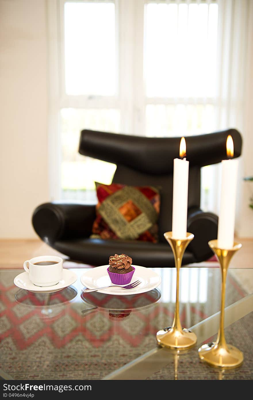 Cupcake and coffee served in the livingroom