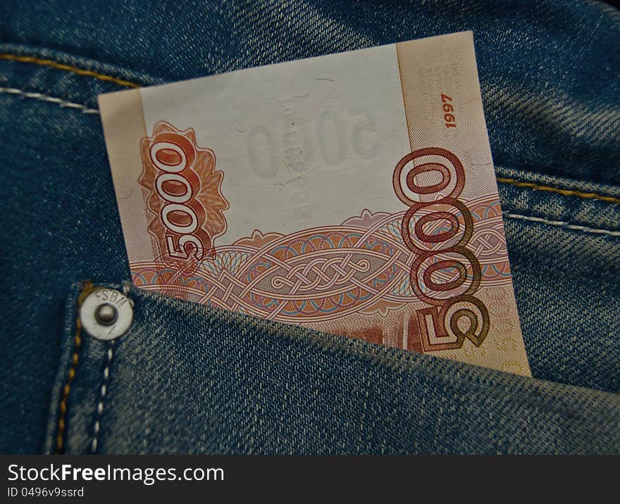 5000 rubles banknote in a blue jeans pocket