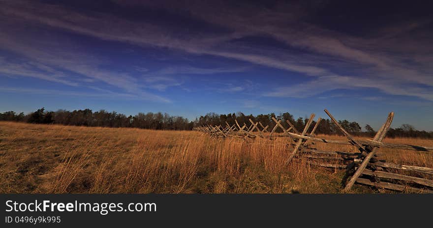 Rural peaceful scenery with deep blue sky and stratus clouds on a sunny winter day