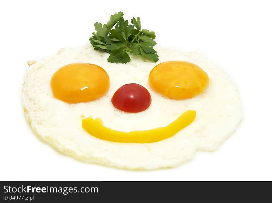 Eggs as a smiley face adorned with greenery on a white plate