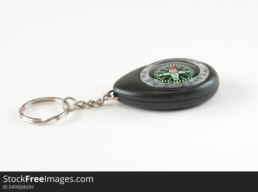 Plastic compass keychain. Shot on a white background.