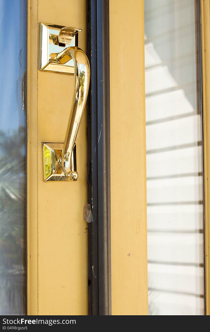 Gold lock and handle door on yellow