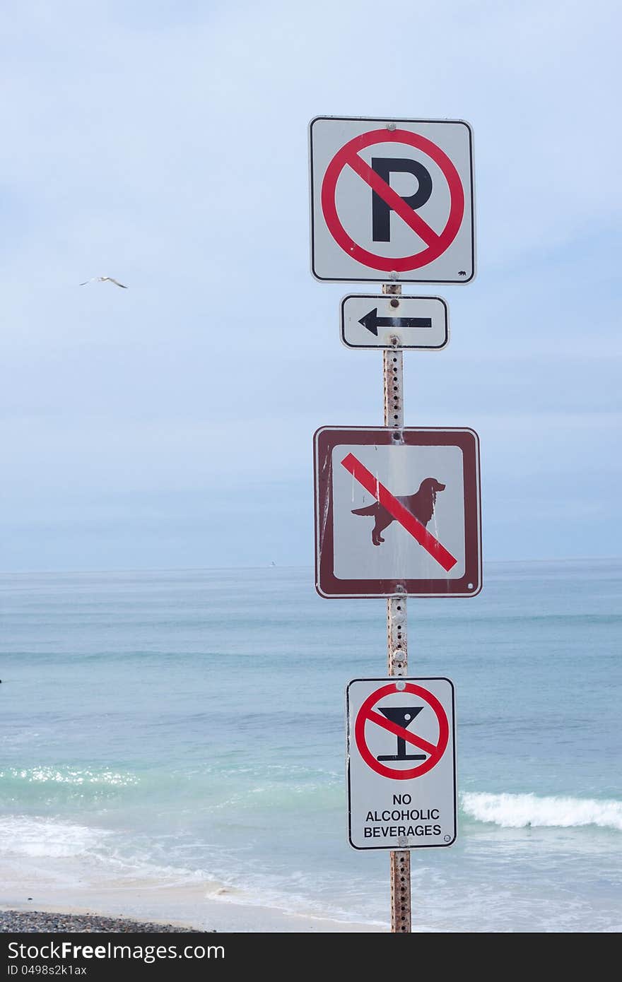 Four warning marks on beach