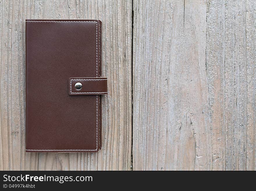 Brown personal notebook on wooden table. Brown personal notebook on wooden table