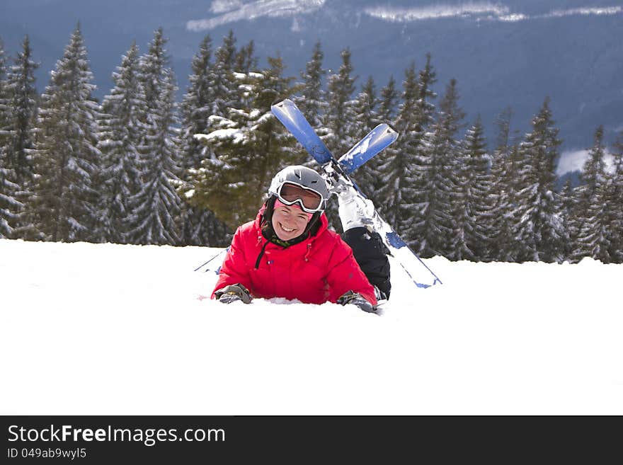 Girl skier lie on the snow