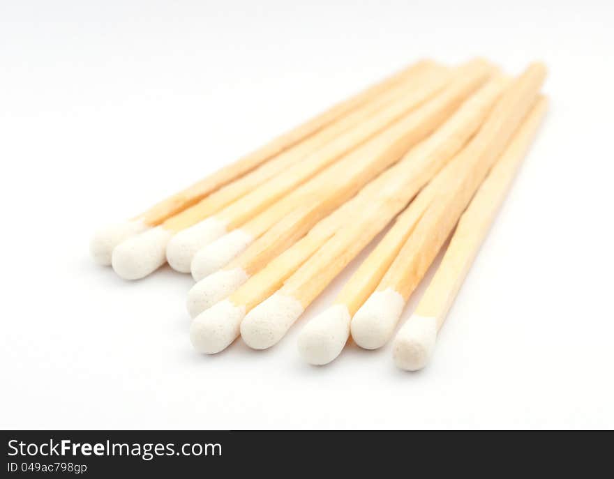 Stack of matches with white heads on white background. Stack of matches with white heads on white background