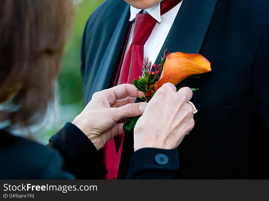 Groom corsage being put on