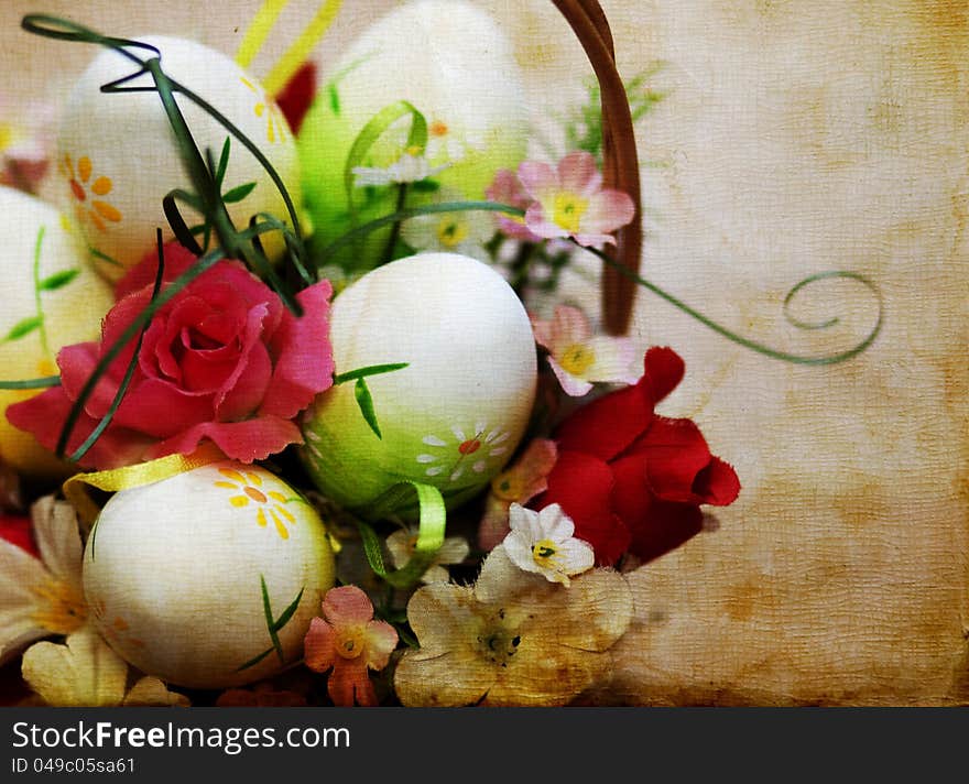 Vintage photo of a basket with easter eggs and flowers