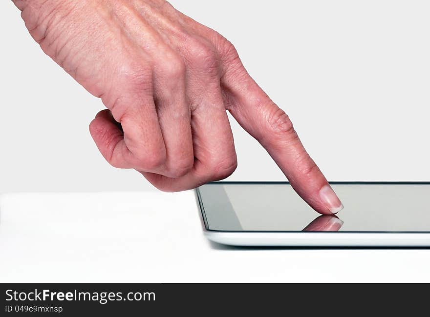 Close up of a finger touching e-tablet. Close up of a finger touching e-tablet