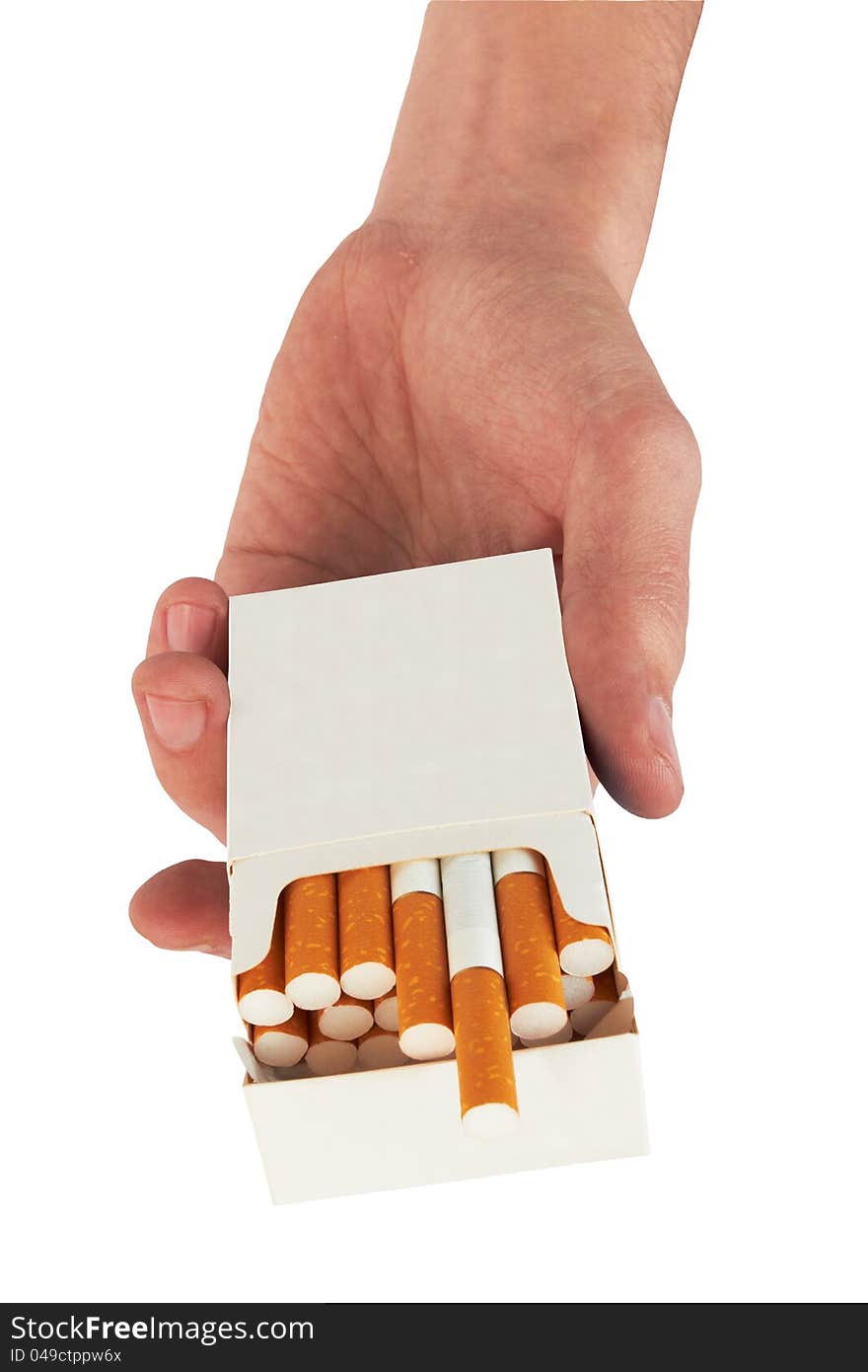 Pack of cigarettes in hand, isolated on white background