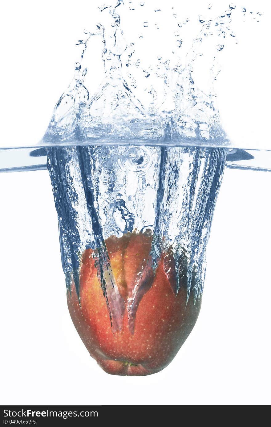 Apple falls deeply under water with a big splash. Apple falls deeply under water with a big splash.