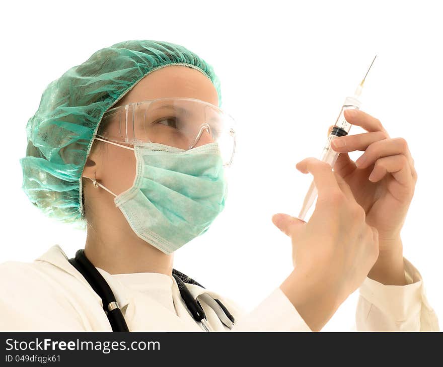 Female doctor wearing a mask, the hands of needles. Wearing white coat. Female doctor wearing a mask, the hands of needles. Wearing white coat.