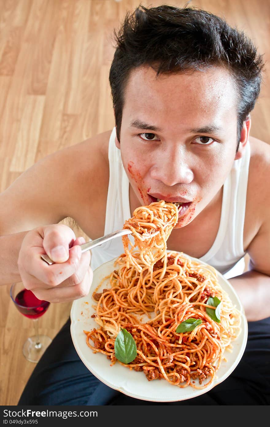 Hungry man is eating spaghetti