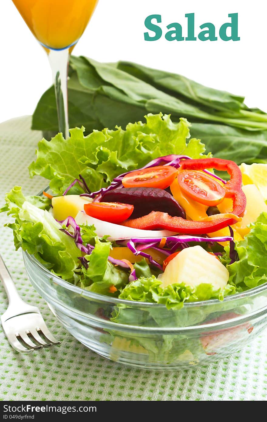 Fresh mix salad and glass of an orange juice