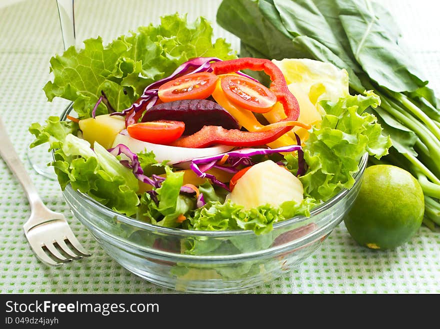 Fresh mix salad and glass of an orange juice