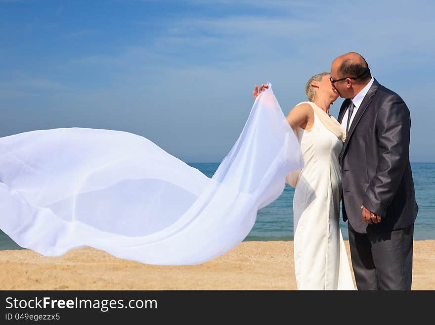 Beautiful couple kissing on the beach