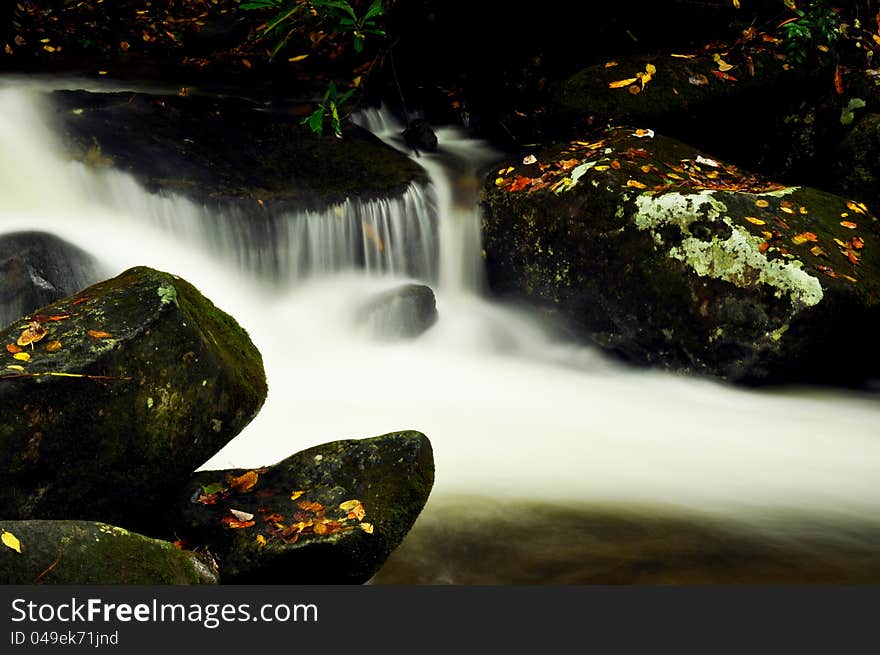 Milky waters flow from a small stream.