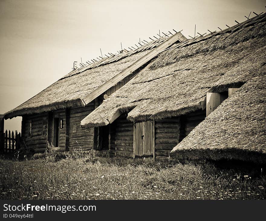 The old wooden houses with thatched roofs in the village