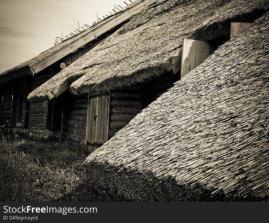 The old wooden houses with thatched roofs in the village