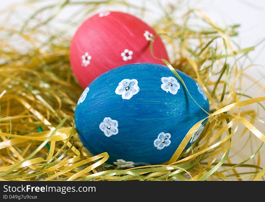 Painted blue and red easter egg with white flowers motifs. Handmade easter decoration. Painted blue and red easter egg with white flowers motifs. Handmade easter decoration.